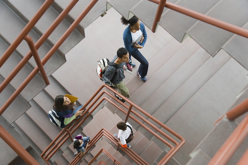 Students walking up staircase, elevated view