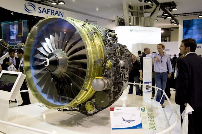 Visitors look at a Safran engine displayed during the 48th Paris Air Show at the Le Bourget airport near Paris
